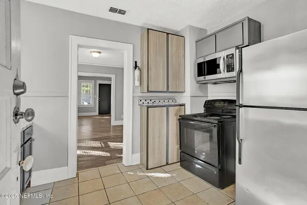 a kitchen with stainless steel appliances granite countertop a refrigerator and a stove