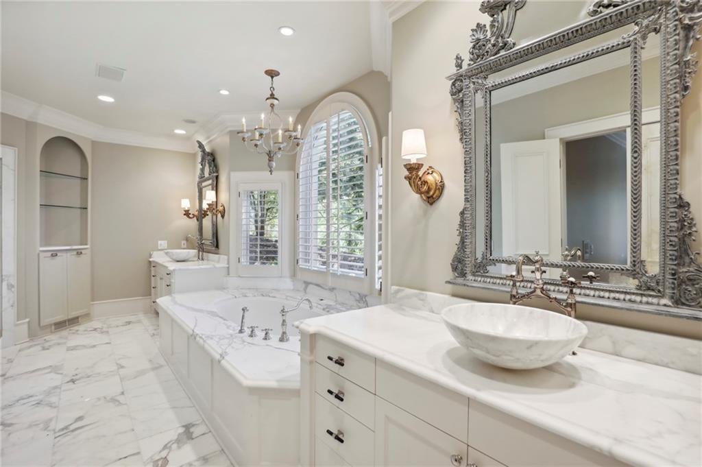 1965 West Wesley Road Northwest Atlanta, GA 30327 - Photo 32 of 34 a spacious bathroom with a granite countertop sink a mirror and a shower