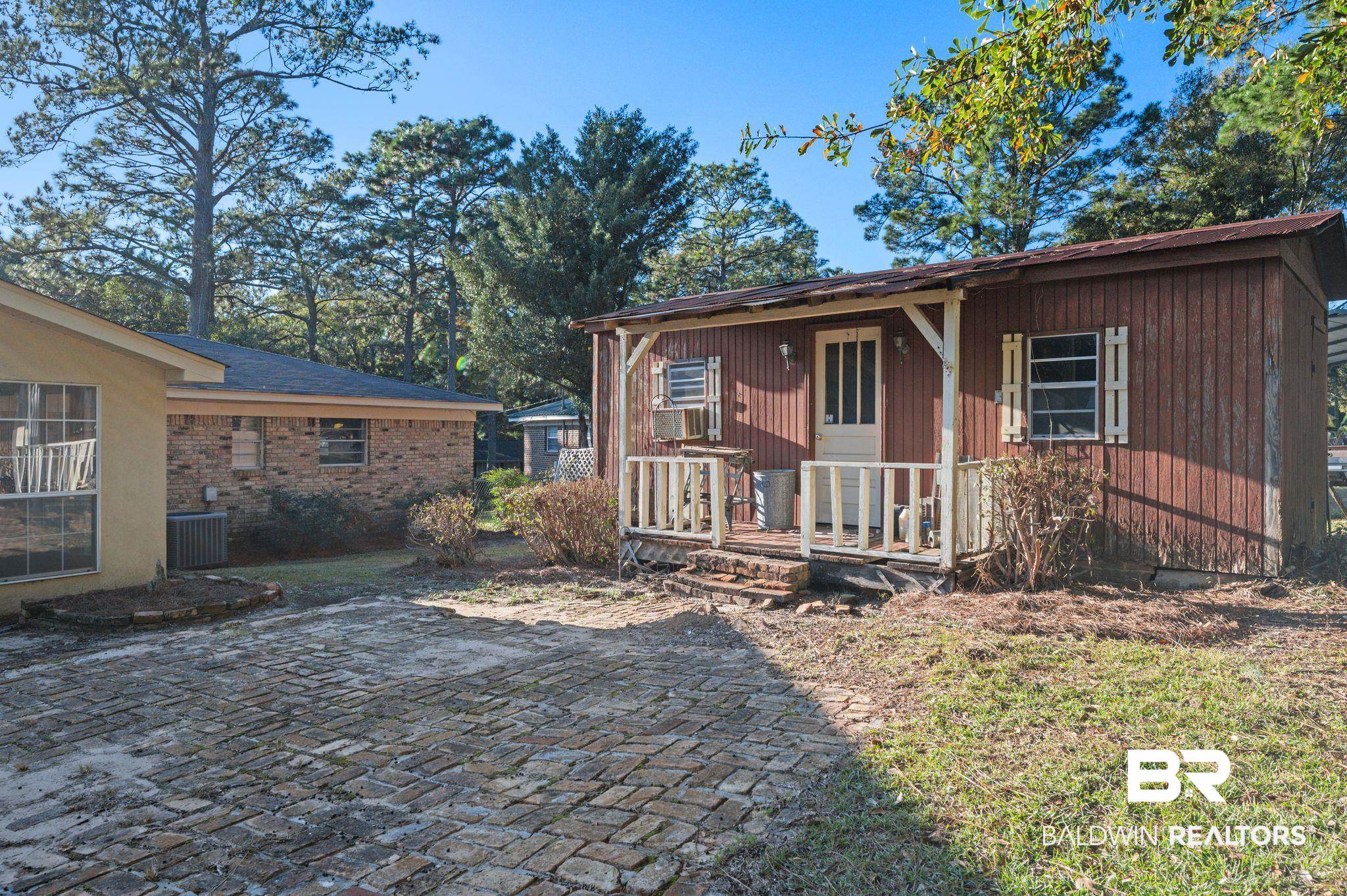 909 Caroline Avenue Daphne, AL 36526 - Photo 41 of 46 View of front facade with central AC unit and a patio