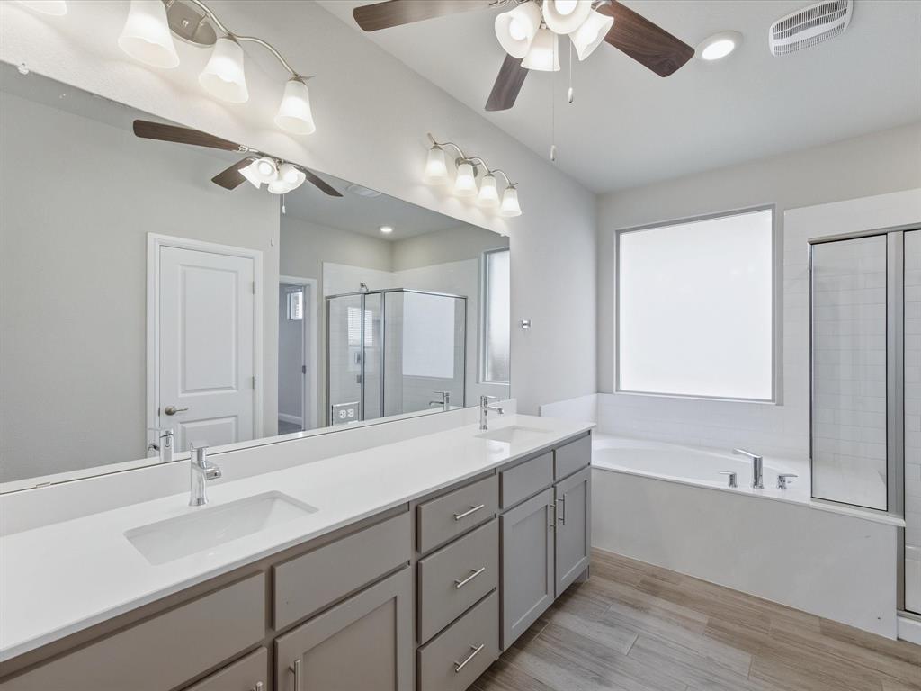 1121 Knightsbridge Road Argyle, TX 76226 - Photo 12 of 39 Primary Bathroom featuring a double vanity with stone countertops, integrated rectangular sinks, and chrome faucets
