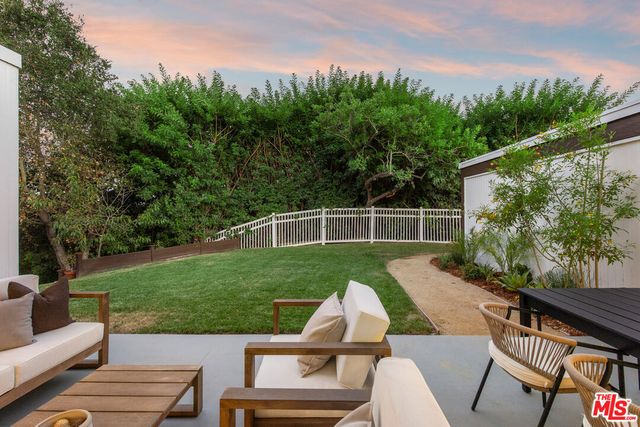 a view of a wooden deck and a garden