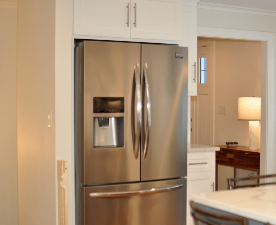 34 Fairbanks Road Lexington, MA 02421 - Photo 15 of 41 a metallic refrigerator freezer sitting in a kitchen