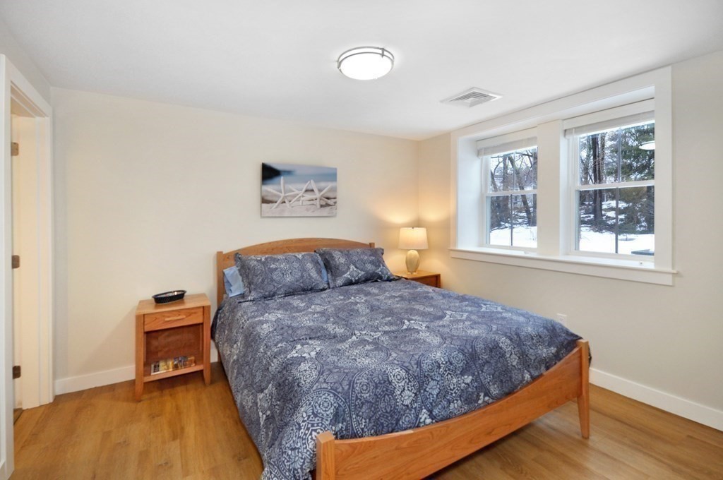 34 Fairbanks Road Lexington, MA 02421 - Photo 36 of 41 a bedroom with a bed and wooden floor