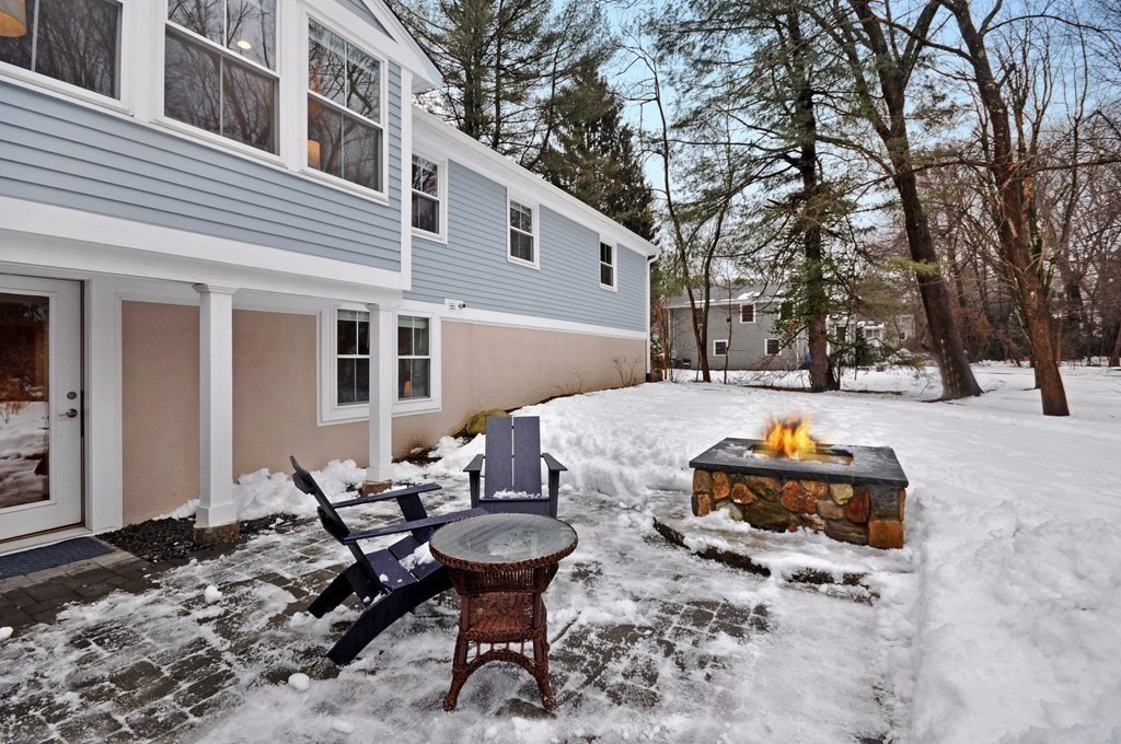 34 Fairbanks Road Lexington, MA 02421 - Photo 38 of 41 a backyard of a house with fire pit table and chairs