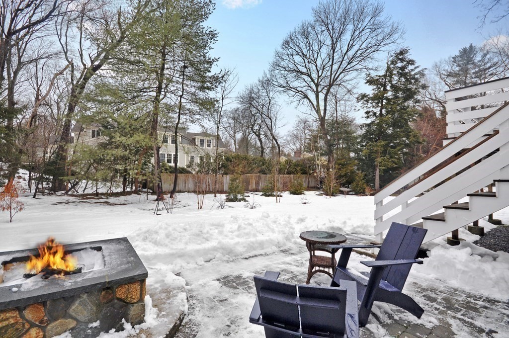 34 Fairbanks Road Lexington, MA 02421 - Photo 39 of 41 a view of a backyard with snow on the road