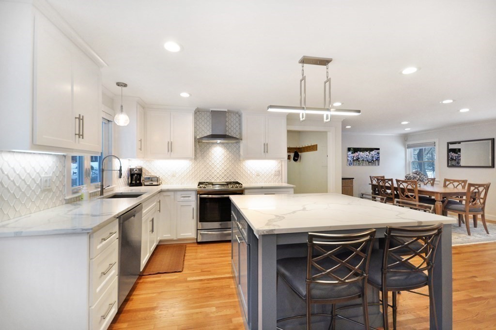 34 Fairbanks Road Lexington, MA 02421 - Photo 5 of 41 a kitchen with a dining table chairs sink and white cabinets