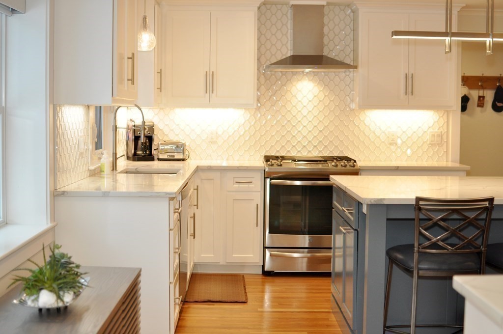 34 Fairbanks Road Lexington, MA 02421 - Photo 6 of 41 a kitchen with stainless steel appliances granite countertop a sink and a stove