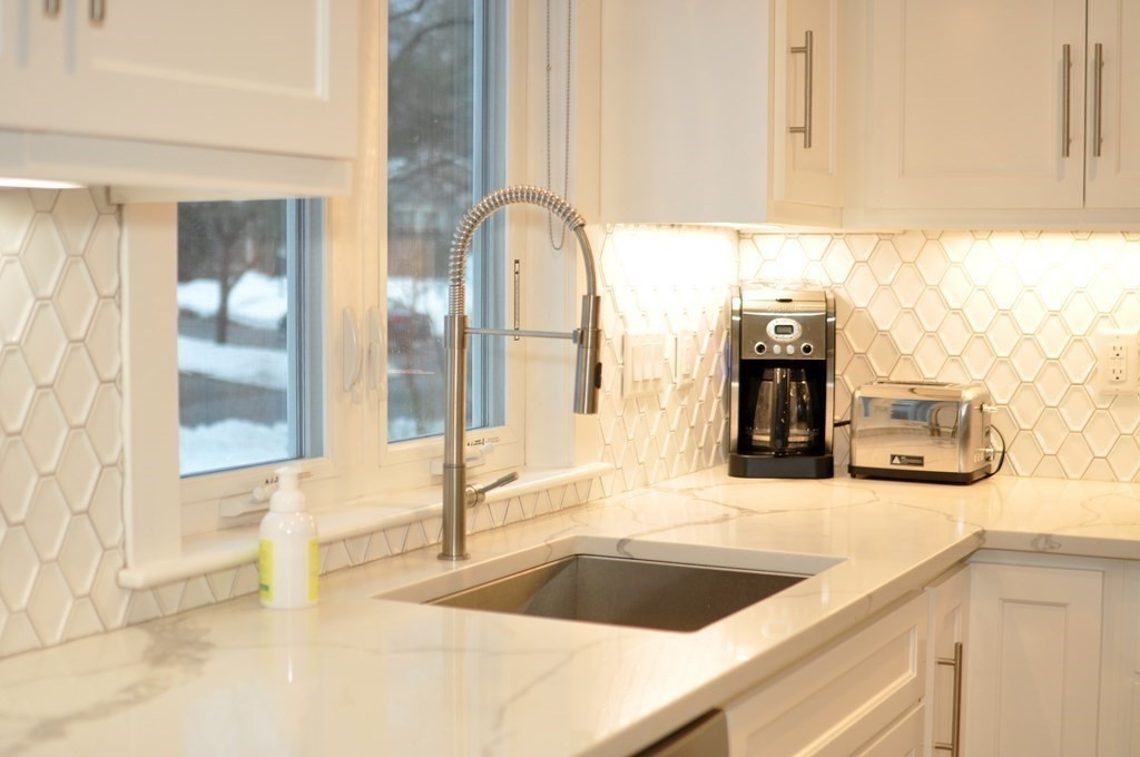 34 Fairbanks Road Lexington, MA 02421 - Photo 7 of 41 a kitchen with granite countertop a sink and a stove next to a window