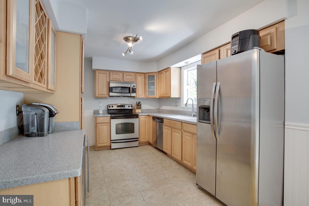 1420 Wilson Road Huntingtown, MD 20639 - Photo 9 of 43 a kitchen with stainless steel appliances granite countertop a refrigerator and a stove