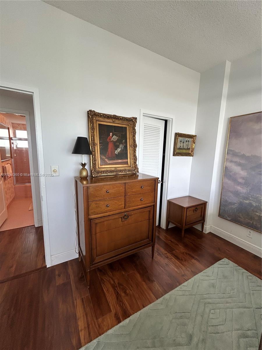 2840 North Ocean Boulevard, Unit 1008 Fort Lauderdale, FL 33308 - Photo 12 of 25 a room with furniture and a wooden floor