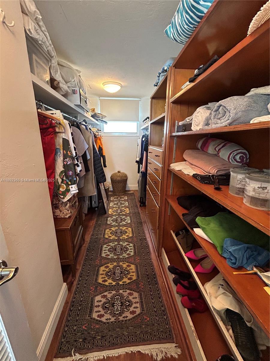 2840 North Ocean Boulevard, Unit 1008 Fort Lauderdale, FL 33308 - Photo 15 of 25 a view of walk in closet with clothes and shoes