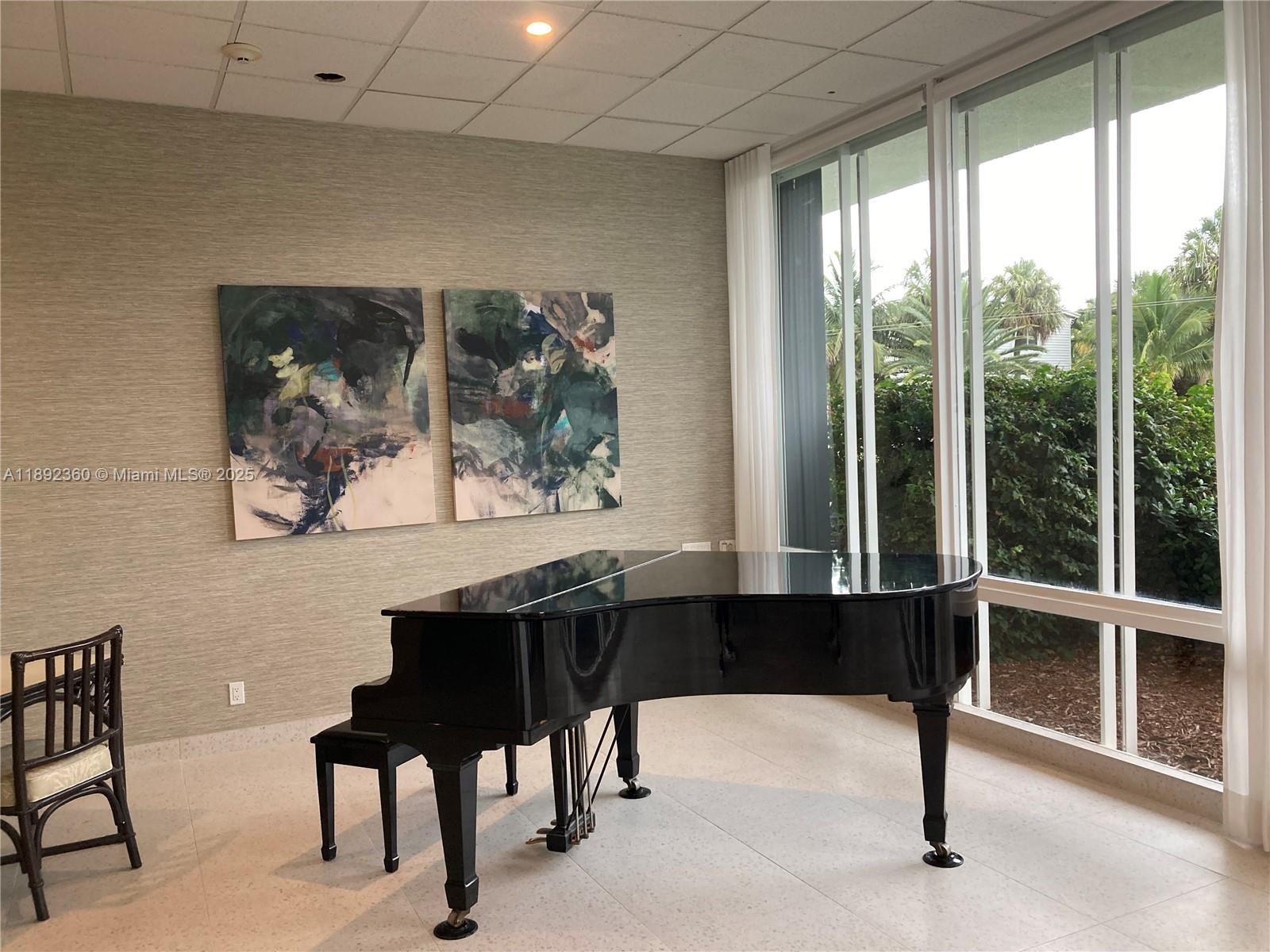 2840 North Ocean Boulevard, Unit 1008 Fort Lauderdale, FL 33308 - Photo 20 of 25 a living room with a large window and a chair
