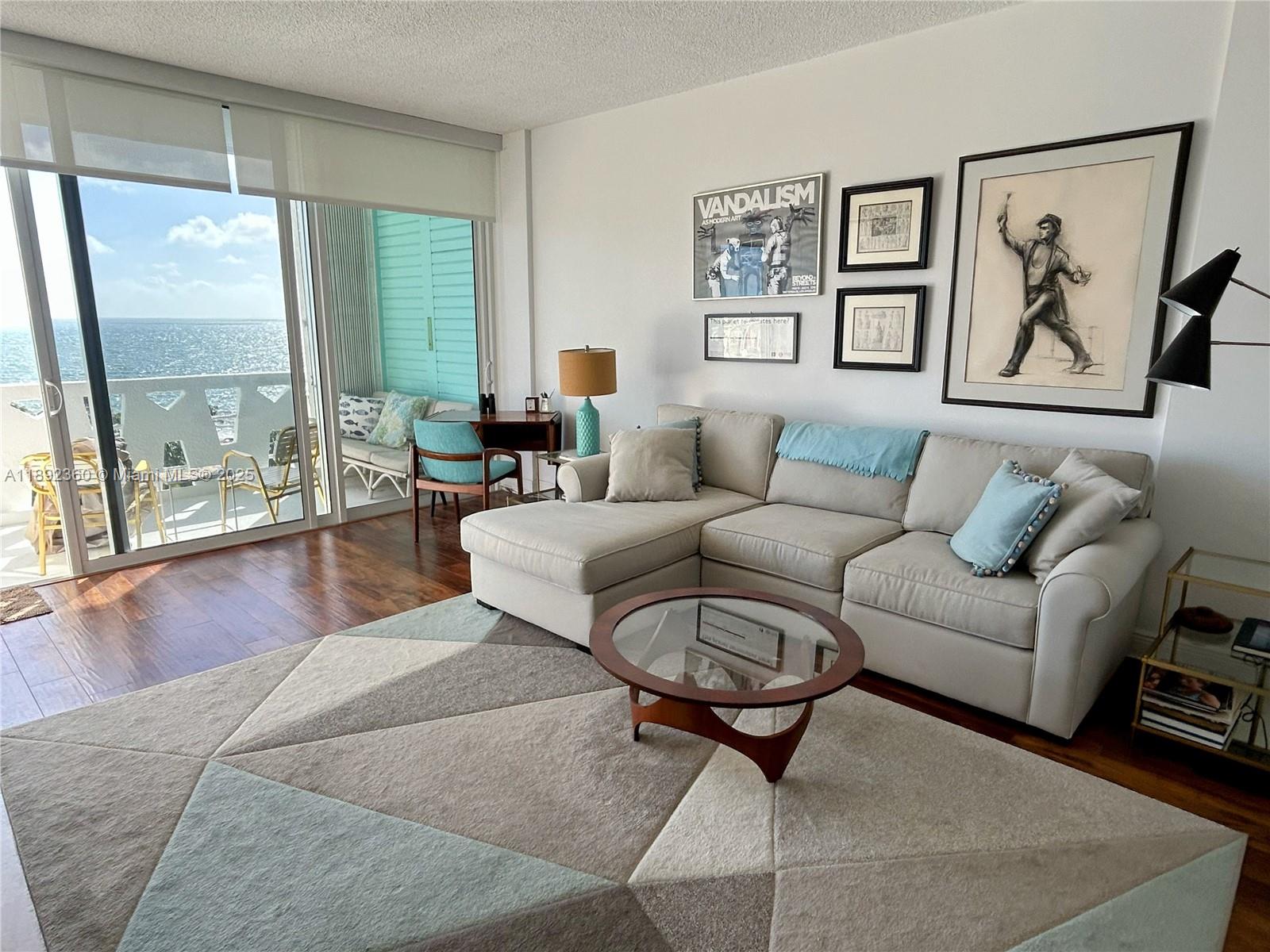 2840 North Ocean Boulevard, Unit 1008 Fort Lauderdale, FL 33308 - Photo 2 of 25 a living room with furniture and a large window