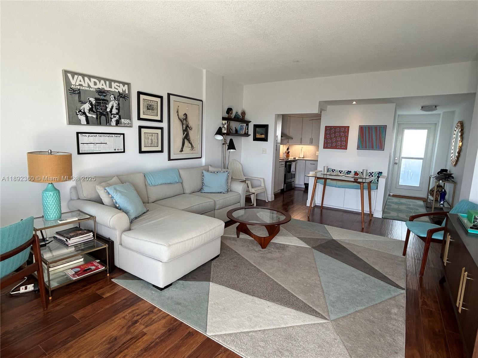 2840 North Ocean Boulevard, Unit 1008 Fort Lauderdale, FL 33308 - Photo 3 of 25 a living room with furniture and wooden floor