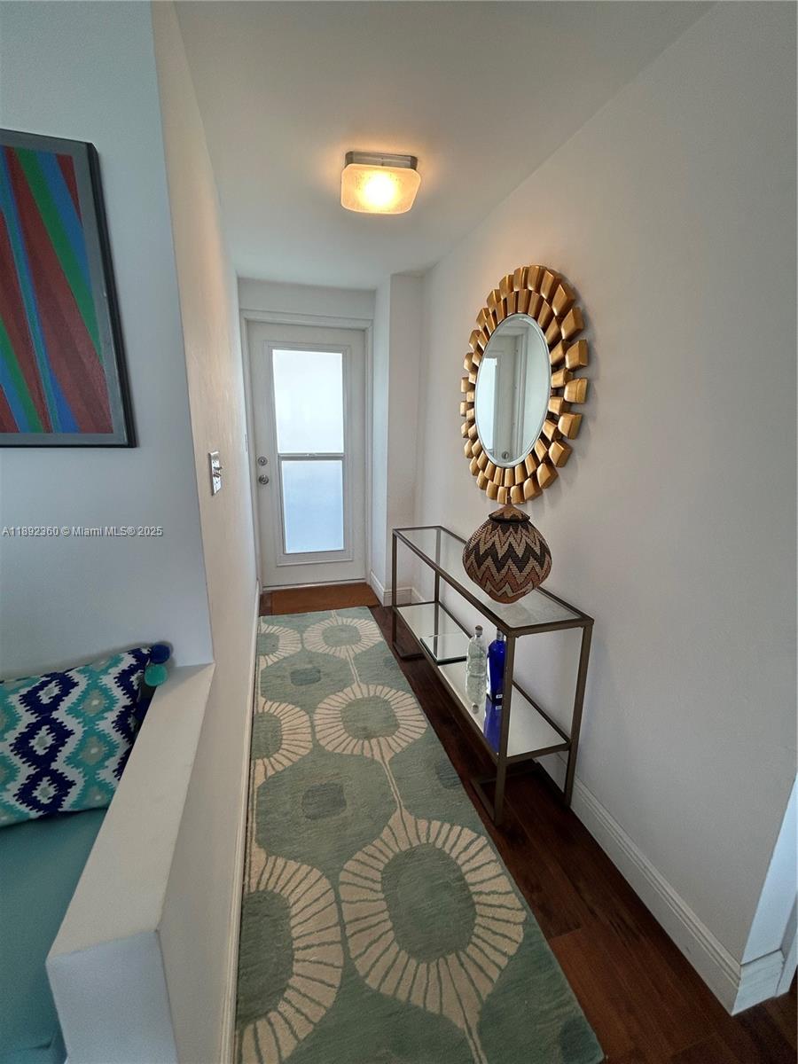 2840 North Ocean Boulevard, Unit 1008 Fort Lauderdale, FL 33308 - Photo 6 of 25 a living room with chair and a table