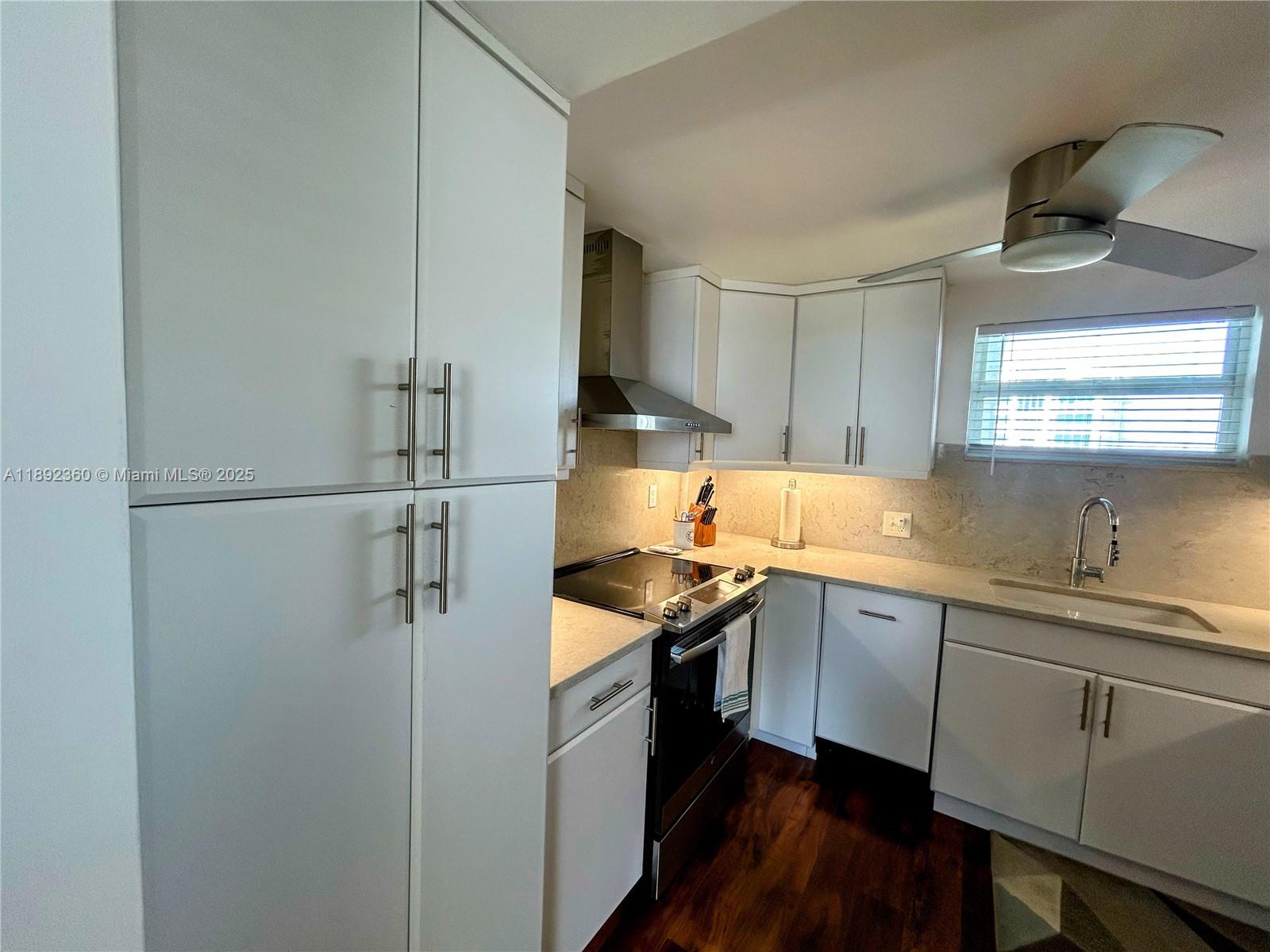 2840 North Ocean Boulevard, Unit 1008 Fort Lauderdale, FL 33308 - Photo 8 of 25 a kitchen with stainless steel appliances granite countertop a sink stove and refrigerator