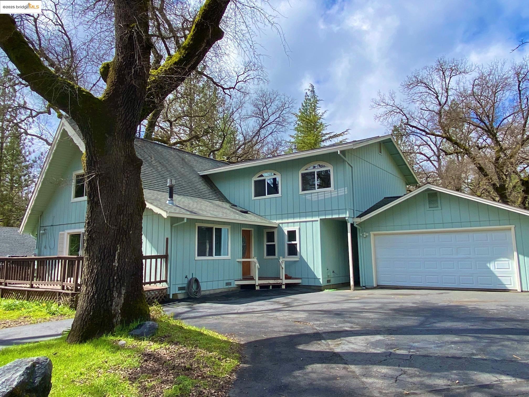 a front view of a house with garden and patio