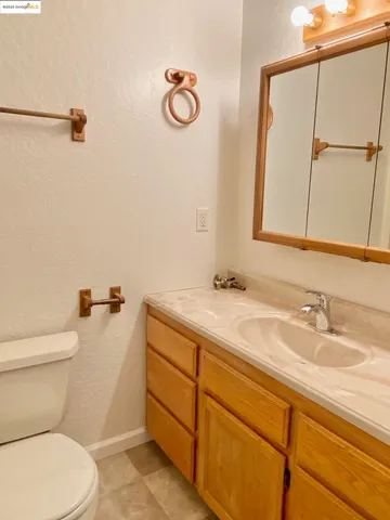a bathroom with a sink a toilet and mirror