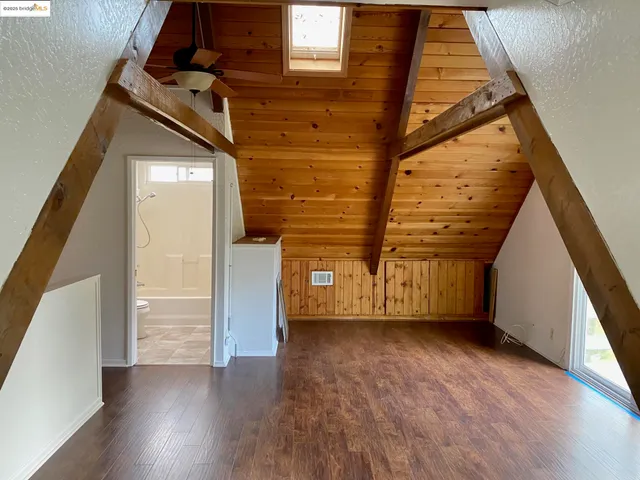a bathroom with a granite countertop bathtub shower sink vanity and toilet