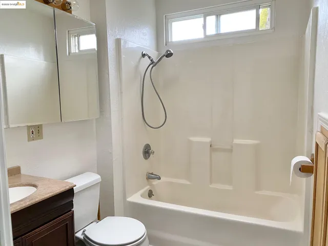 a view of a room with wooden floor and door