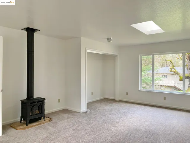 a backyard of a house with barbeque oven and seating space