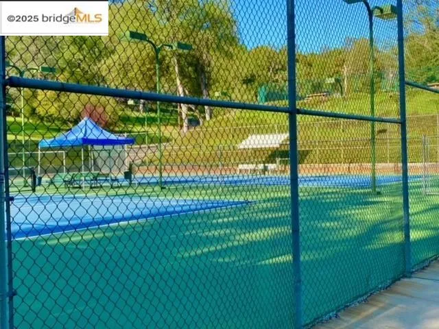 a view of swimming pool with a wooden fence