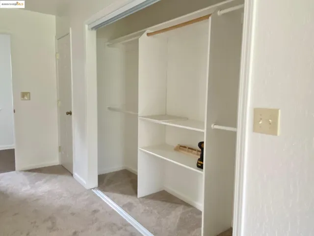 a view of closet area with empty racks
