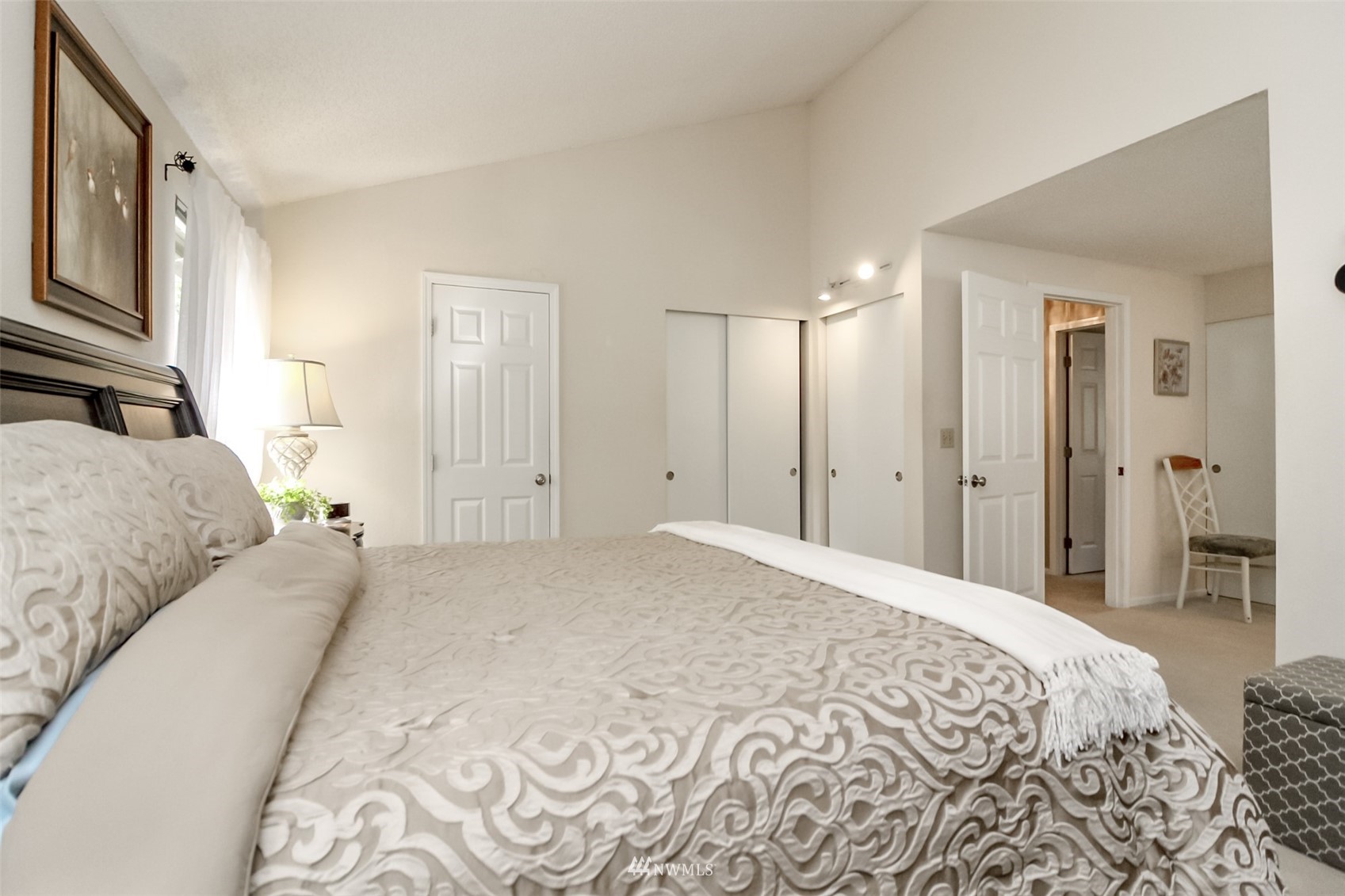 15007 Southeast 145th Place Renton, WA 98059 - Photo 13 of 34 a spacious bedroom with a bed and a lamp