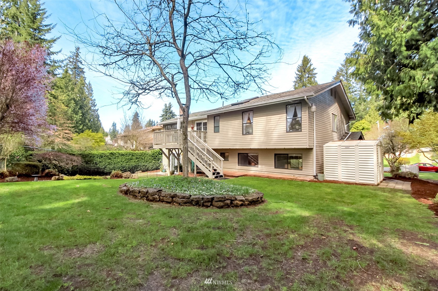 15007 Southeast 145th Place Renton, WA 98059 - Photo 27 of 34 a view of a house with a big yard and large trees
