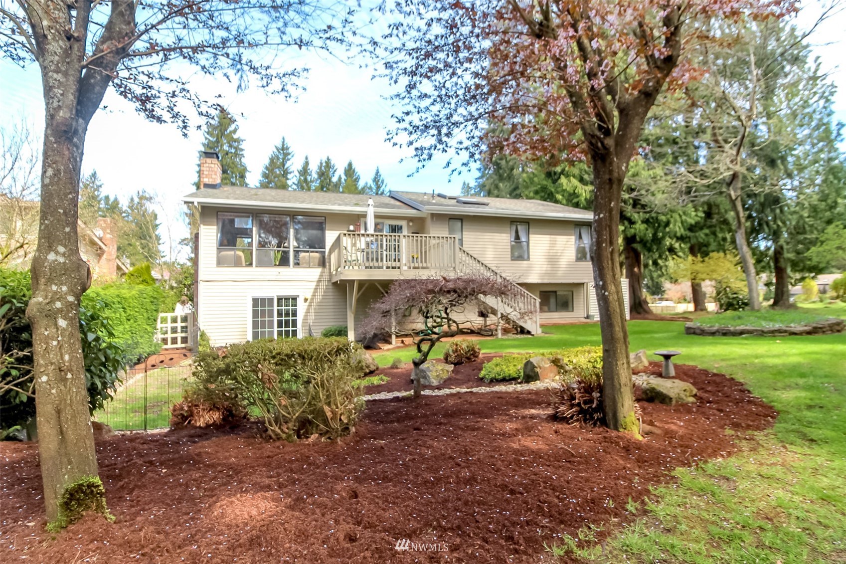 15007 Southeast 145th Place Renton, WA 98059 - Photo 30 of 34 a view of house with a backyard and trees