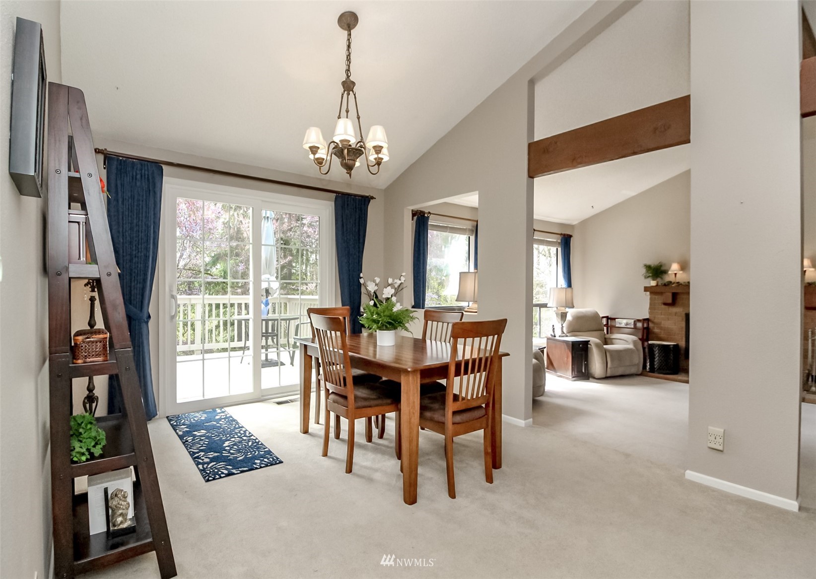 15007 Southeast 145th Place Renton, WA 98059 - Photo 3 of 34 a view of a dining room and livingroom with furniture wooden floor a chandelier