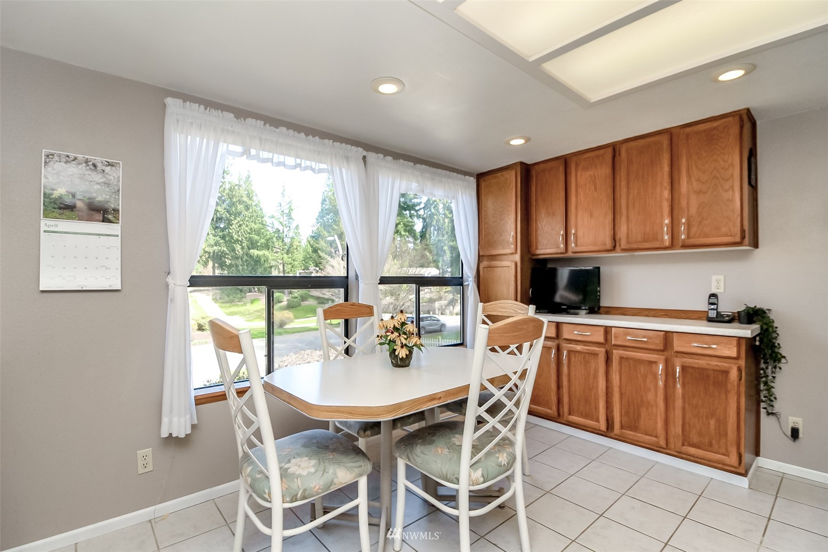 15007 Southeast 145th Place Renton, WA 98059 - Photo 10 of 34 a kitchen with a dining table chairs and large window