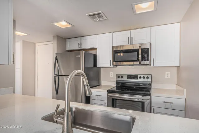 an empty room with fan and entryway