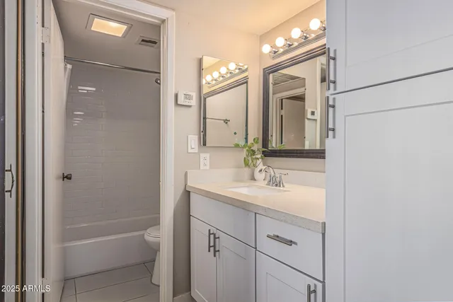 a bathroom with a toilet and a bath tub