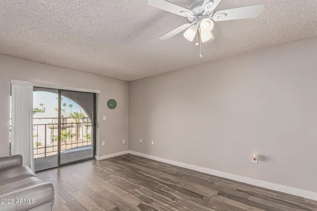 a view of a living room hardwood floor and a ceiling fan