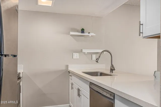 a kitchen with stainless steel appliances a refrigerator stove and microwave