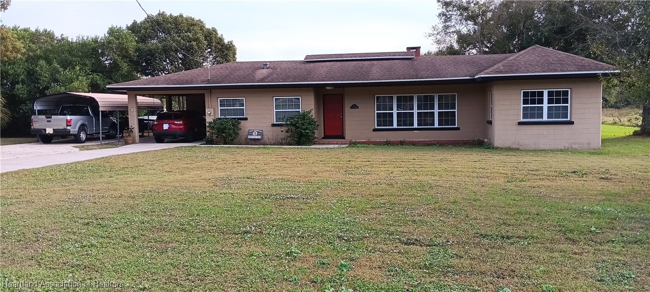 715 Stenstrom Road Wauchula, FL 33873 - Photo 2 of 11 a front view of a house with a garden