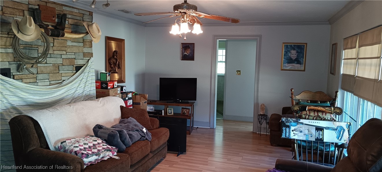 715 Stenstrom Road Wauchula, FL 33873 - Photo 6 of 11 a living room with furniture and a flat screen tv