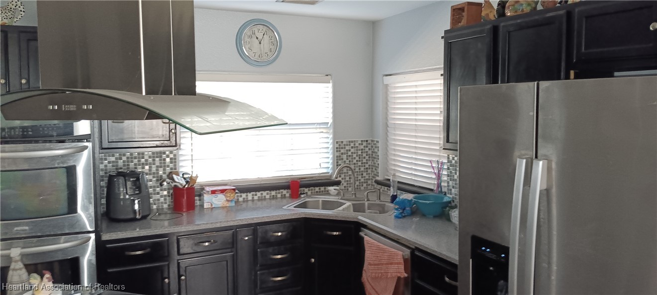 715 Stenstrom Road Wauchula, FL 33873 - Photo 9 of 11 a kitchen with a sink and a refrigerator