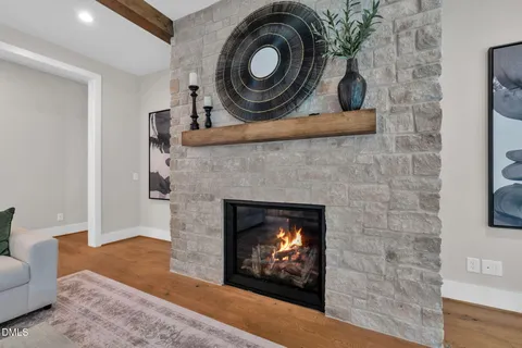 a open kitchen with stainless steel appliances granite countertop a stove a refrigerator a kitchen island a dining table and chairs