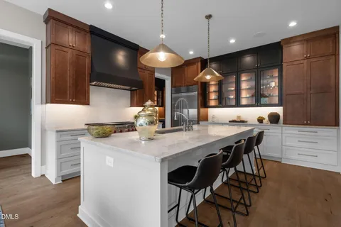 a kitchen with stainless steel appliances granite countertop cabinets and window