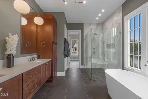 an empty room with a window and a ceiling fan