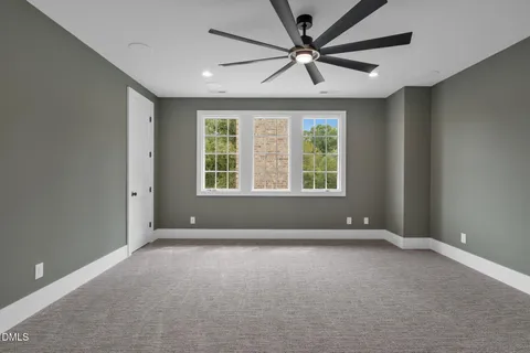 a view of a swimming pool and lounge chairs in back yard