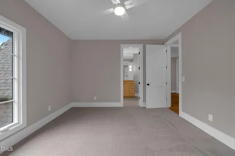 a view of a house with potted plants and a table