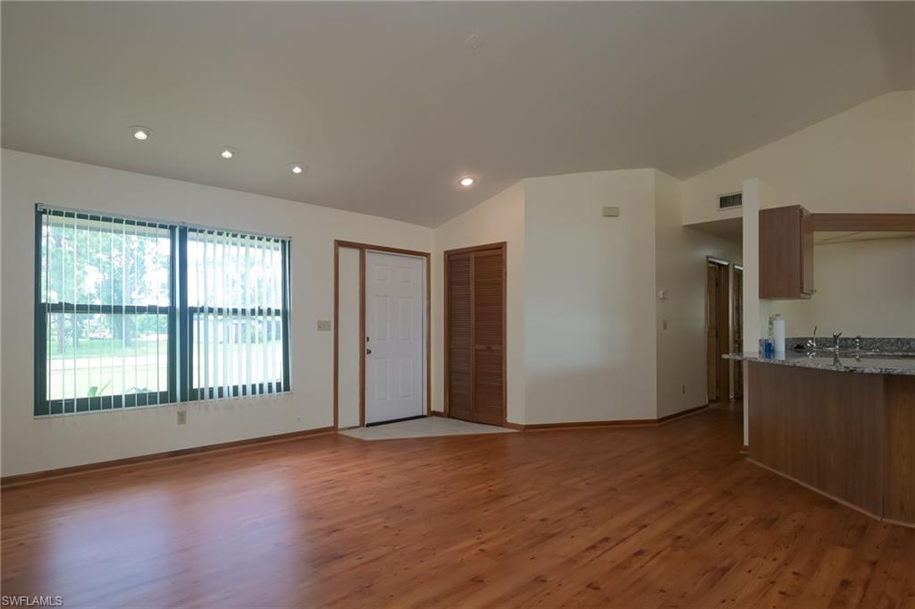 18303 Lee Road Fort Myers, FL 33967 - Photo 6 of 31 a view of a kitchen with refrigerator and wooden floor