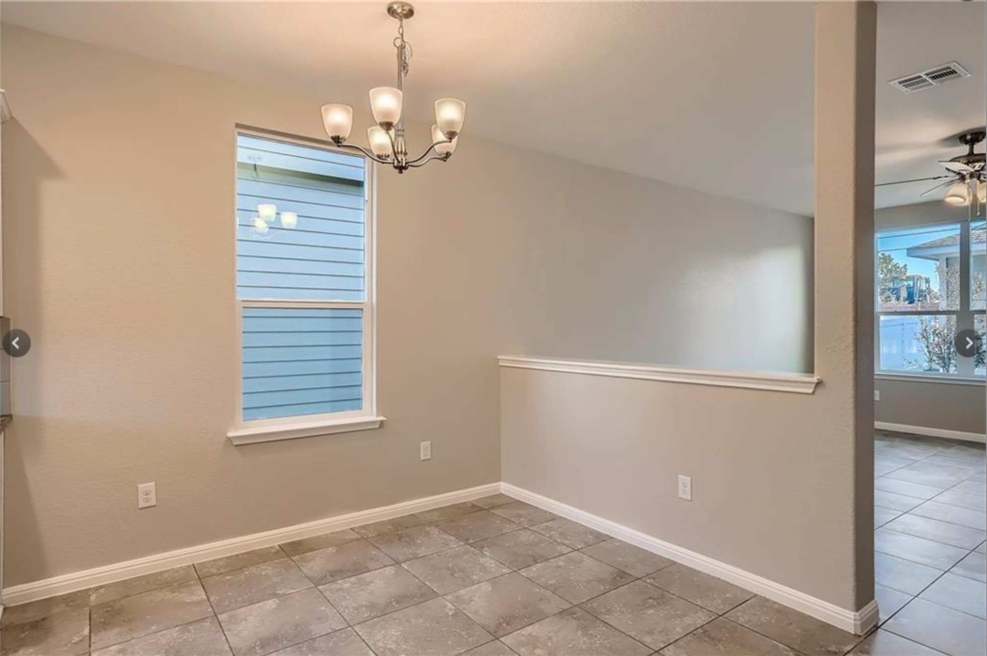 304 Cane River Road Pflugerville, TX 78660 - Photo 13 of 31 A well-lit dining area features a modern chandelier and tiled flooring.