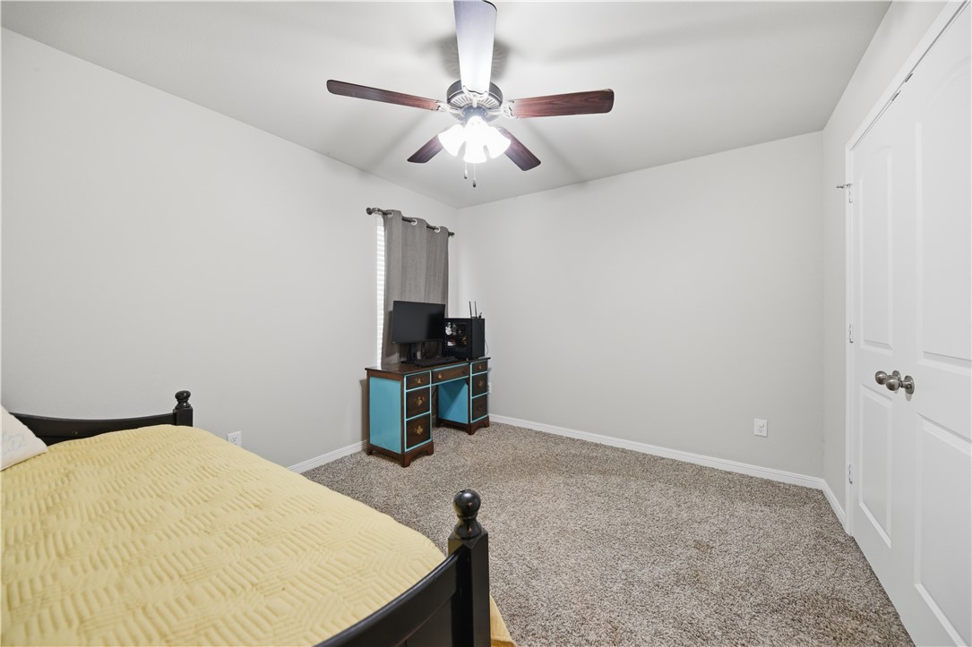 808 Mockingbird Street Navasota, TX 77868 - Photo 15 of 19 a bedroom with a bed and a chandelier