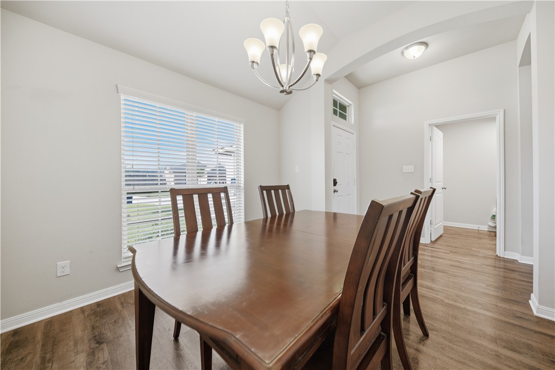 808 Mockingbird Street Navasota, TX 77868 - Photo 5 of 19 a view of a dining room with furniture and wooden floor