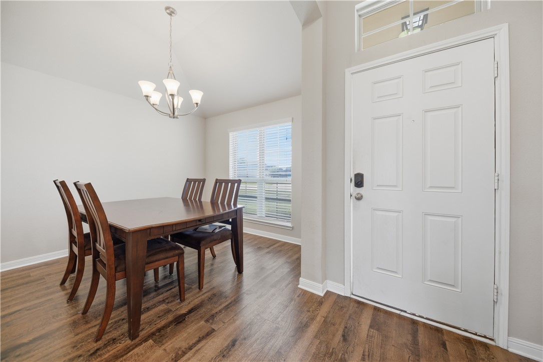 808 Mockingbird Street Navasota, TX 77868 - Photo 6 of 19 a view of a dining room with furniture wooden floor and chandelier