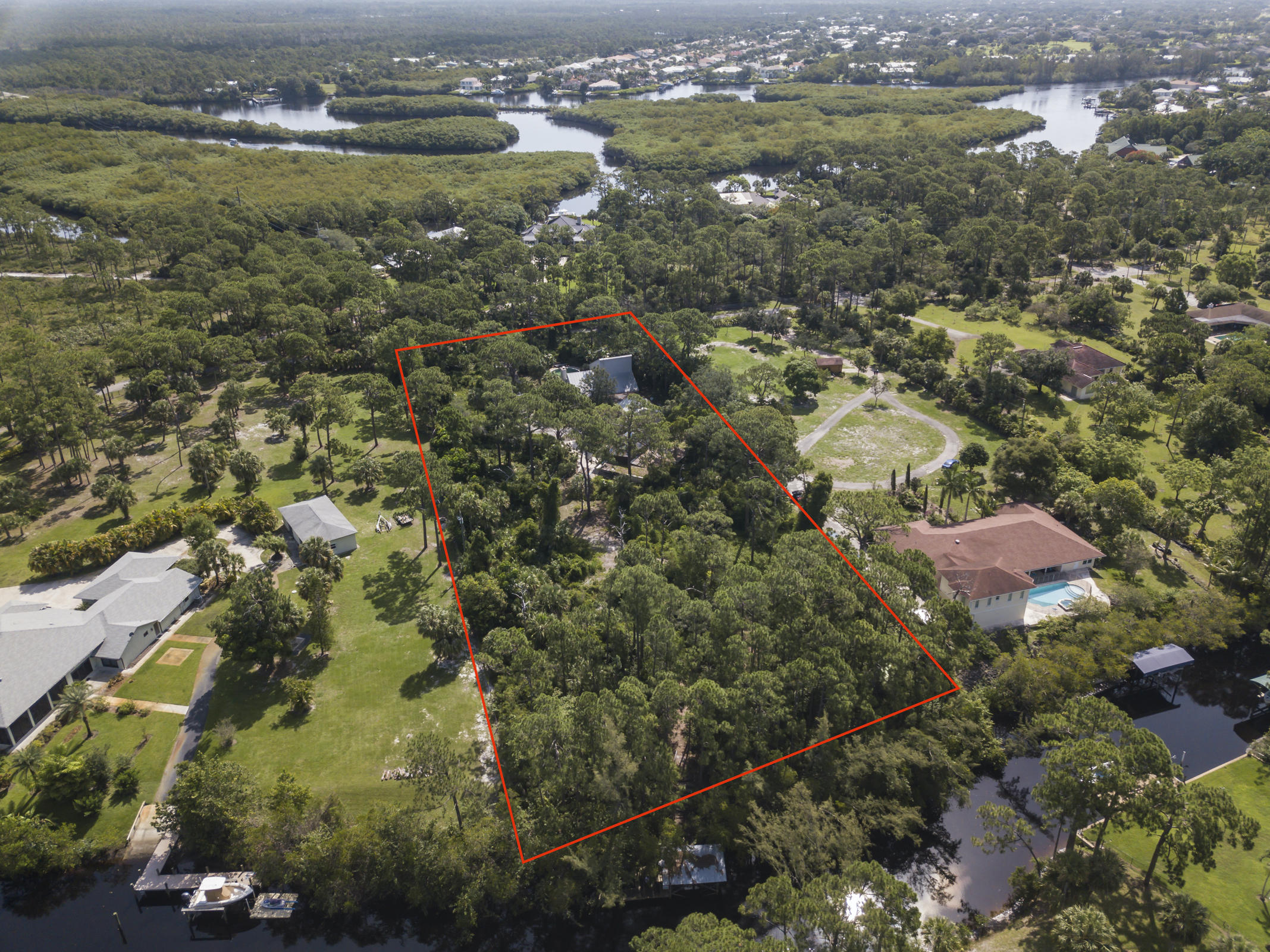 7169 Southeast Rivers Edge Street Jupiter, FL 33458 - Photo 1 of 39 an aerial view of residential houses with outdoor space and lake view